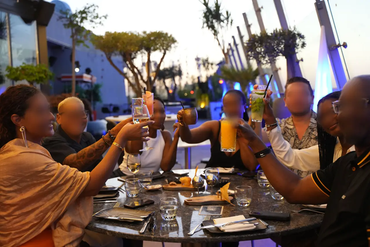 A group toasting on the terrace at sunset